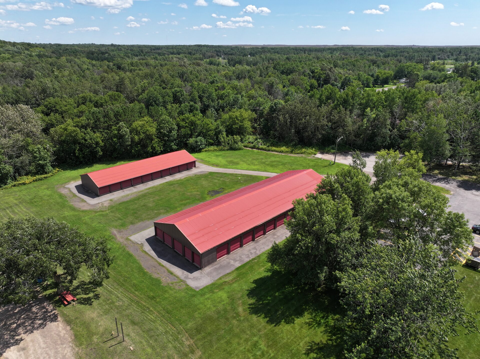 Aerial view of Pleasant Lake Storage — two buildings, gated facility in Hackensack, MN