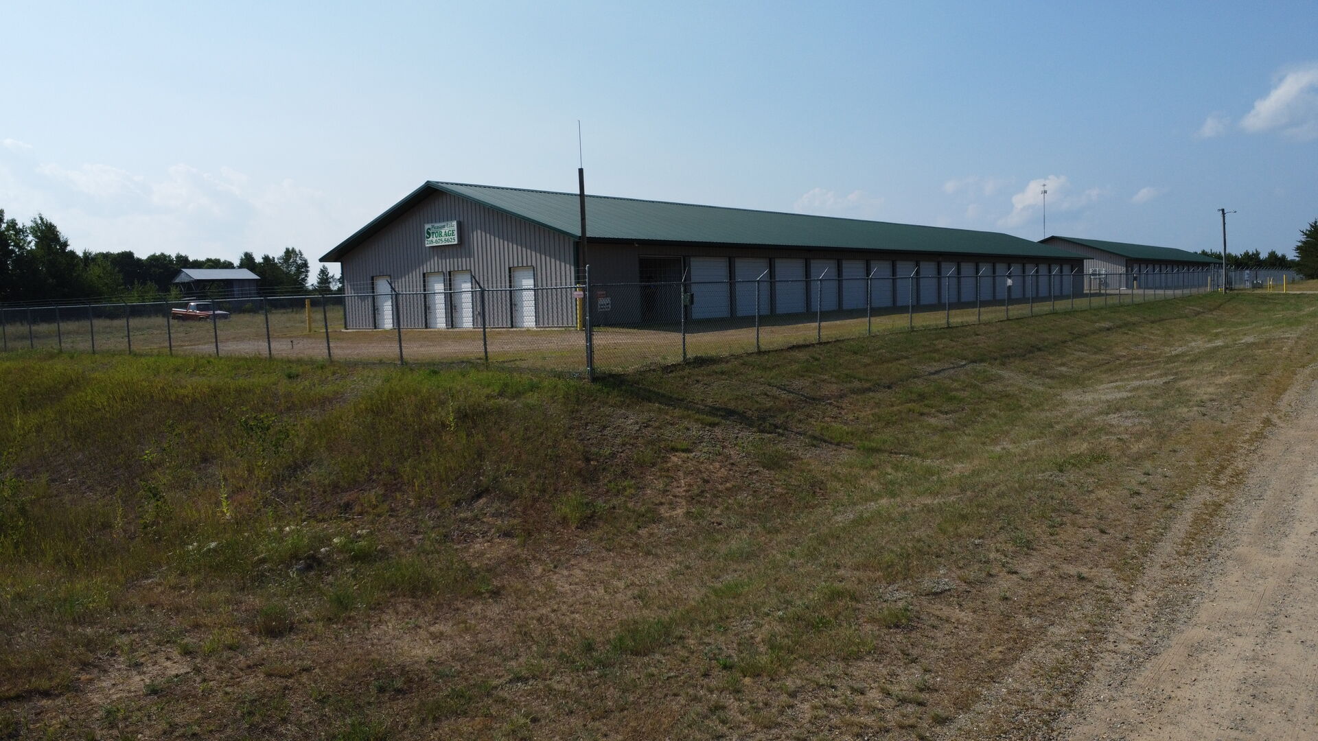 Pleasant Lake Storage entrance — gated and fenced, Pleasant Lake Storage sign visible